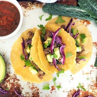 These family favorite beef and kale tacos are sure to be a hit at your dinner table! Plain grass fed ground beef gets a nutrient and flavor boost from fresh chopped onions and kale. This is a great way to get leafy greens into your kids! #glutenfree #dairyfree