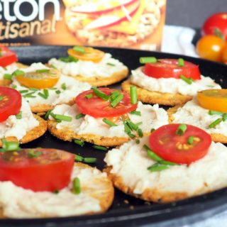#ad Need a healthy but simple appetizer idea for your next get-together? These crackers with white bean dip, tomatoes, and chives are perfect! Use summer fresh grape or cherry tomatoes for maximum flavor! #vegan From halsanutrition.com