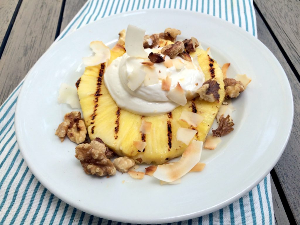 grilled pineapple with cream, coconut and walnuts