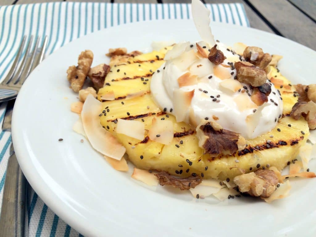 grilled pineapple with cream, coconut, & walnuts - this is a fresh, tasty summer dessert that is festive enough for entertaining but if you have an avid griller in the family it would also make a really festive weekend breakfast!