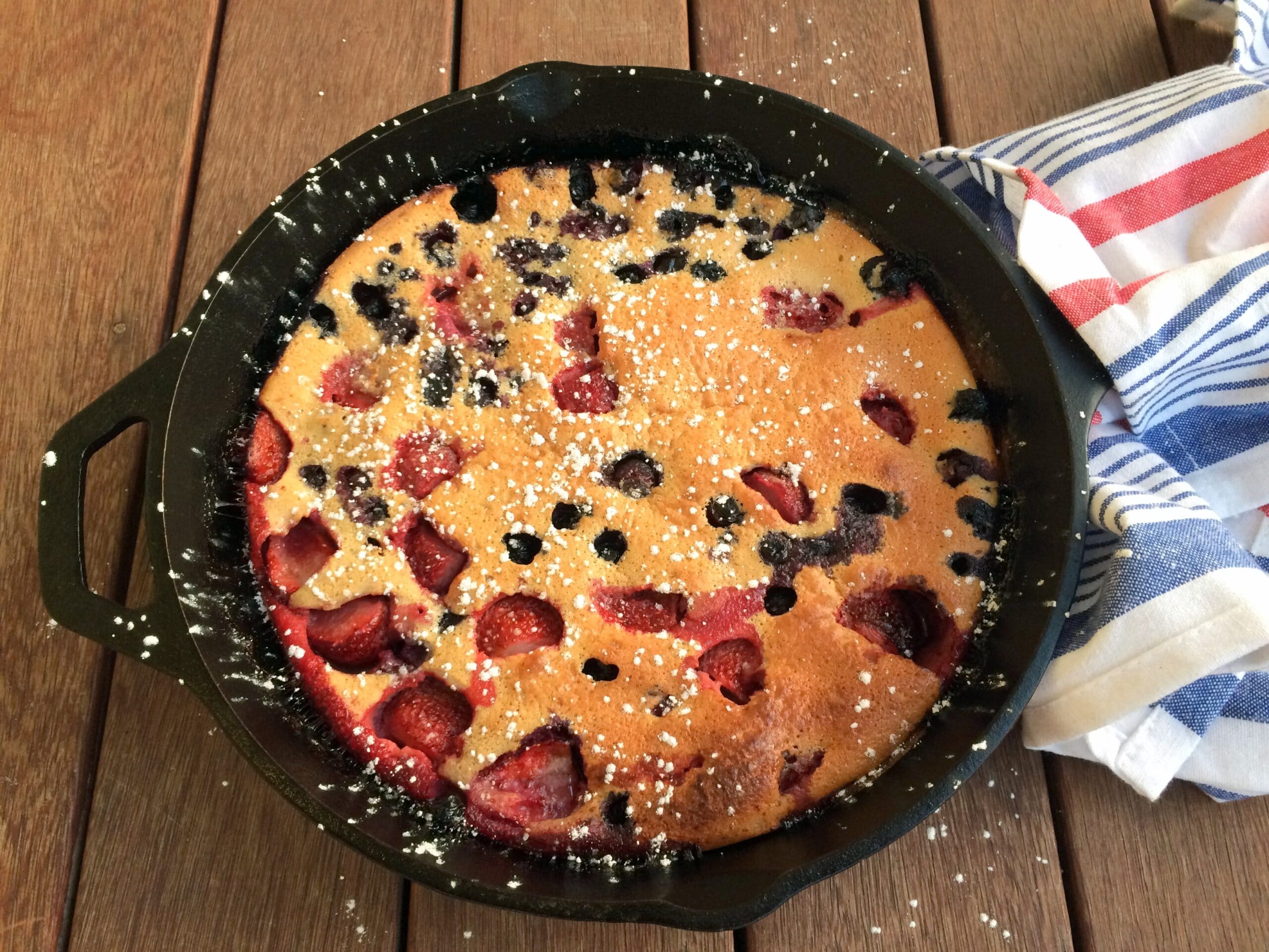 This amazingly simple berry clafoutis is not only delicious but also healthy! Made with whole wheat flour, almond flour, it is also dairy-free and lower in sugar than a traditional clafloutis. It is a bit of a Dutch Baby - Clafoutis hybrid, and it's healthful properties make it a perfect way to start or end your day! It's so easy to make: just combine ingredients in a blender, pour into a heated and greased 10-inch cast-iron pan, and start checking for doneness at 18 minutes. Enjoy!