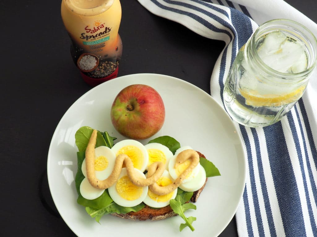 A simple, healthy way to liven up your egg sandwich! Simply add some peppery arugula and top with Sabra's delicious sea salt & cracked pepper hummus spread. Eat it like the Nordic, open-faced, or top it with another piece of bread for a classic lunch-box sandwich. Yum! Dairy-free, vegetarian.