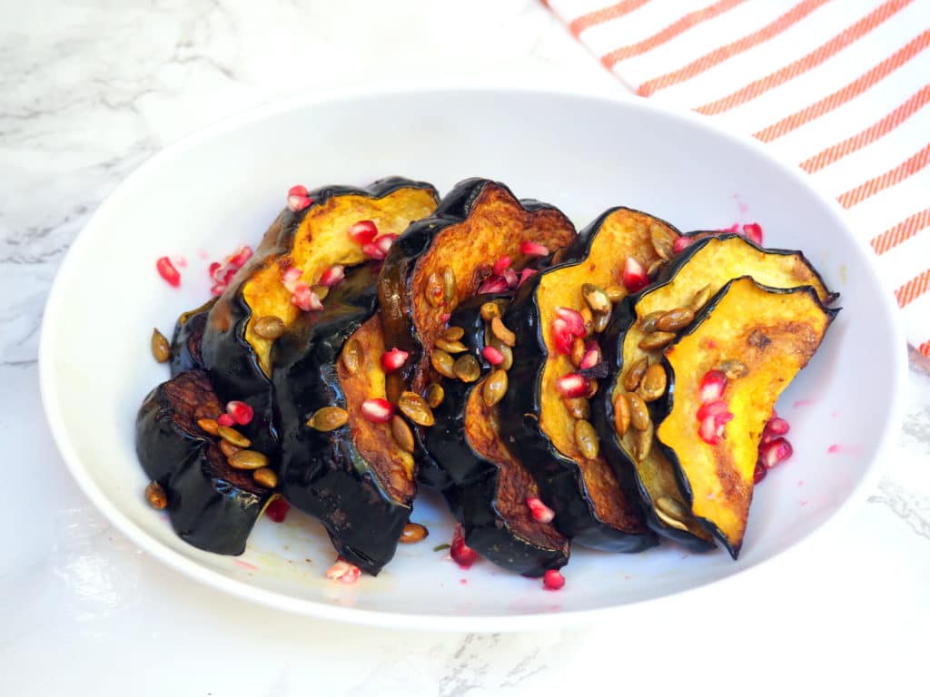 this pomegranate topped roasted acorn squash makes a festive side dish for the holiday season!