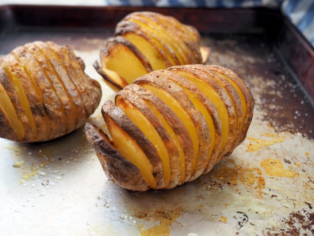 #ad This smoked salmon stuffed Hasselback potato is delicious any time of day--brunch, lunch or dinner! It's nutrient composition of complex carbs, protein, and potassium also makes it ideal for refueling after a workout. Give this nordic-inspired potato a try today! #gluten-free #thereciperedux