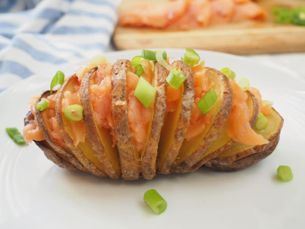 #ad This smoked salmon stuffed Hasselback potato is delicious any time of day--brunch, lunch or dinner! It's nutrient composition of complex carbs, protein, and potassium also makes it ideal for refueling after a workout. Give this nordic-inspired potato a try today! #gluten-free #thereciperedux