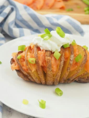 #ad This smoked salmon stuffed Hasselback potato is delicious any time of day--brunch, lunch or dinner! It's nutrient composition of complex carbs, protein, and potassium also makes it ideal for refueling after a workout. Give this nordic-inspired potato a try today! #gluten-free