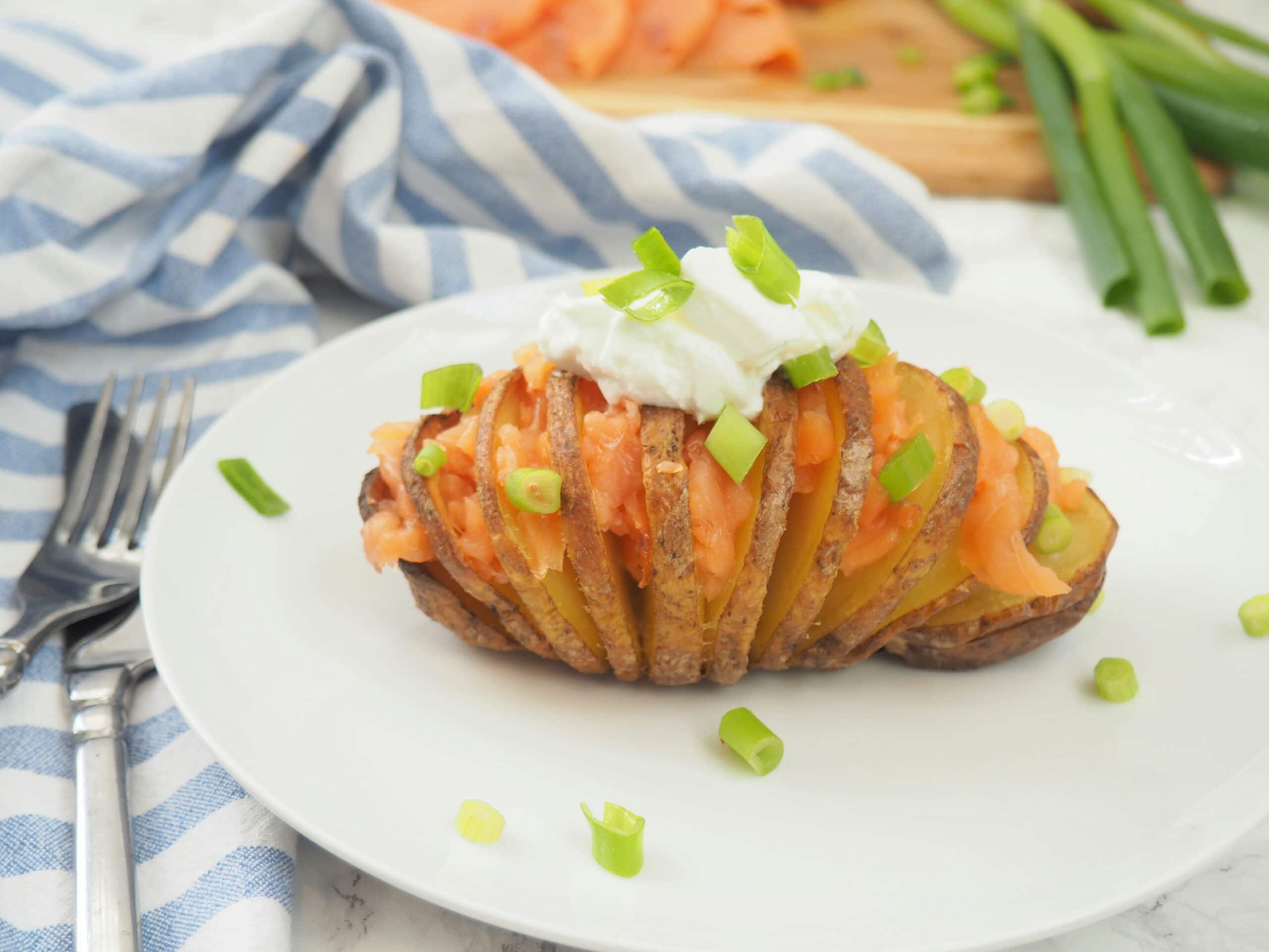 #ad This smoked salmon stuffed Hasselback potato is delicious any time of day--brunch, lunch or dinner! It's nutrient composition of complex carbs, protein, and potassium also makes it ideal for refueling after a workout. Give this nordic-inspired potato a try today! #gluten-free