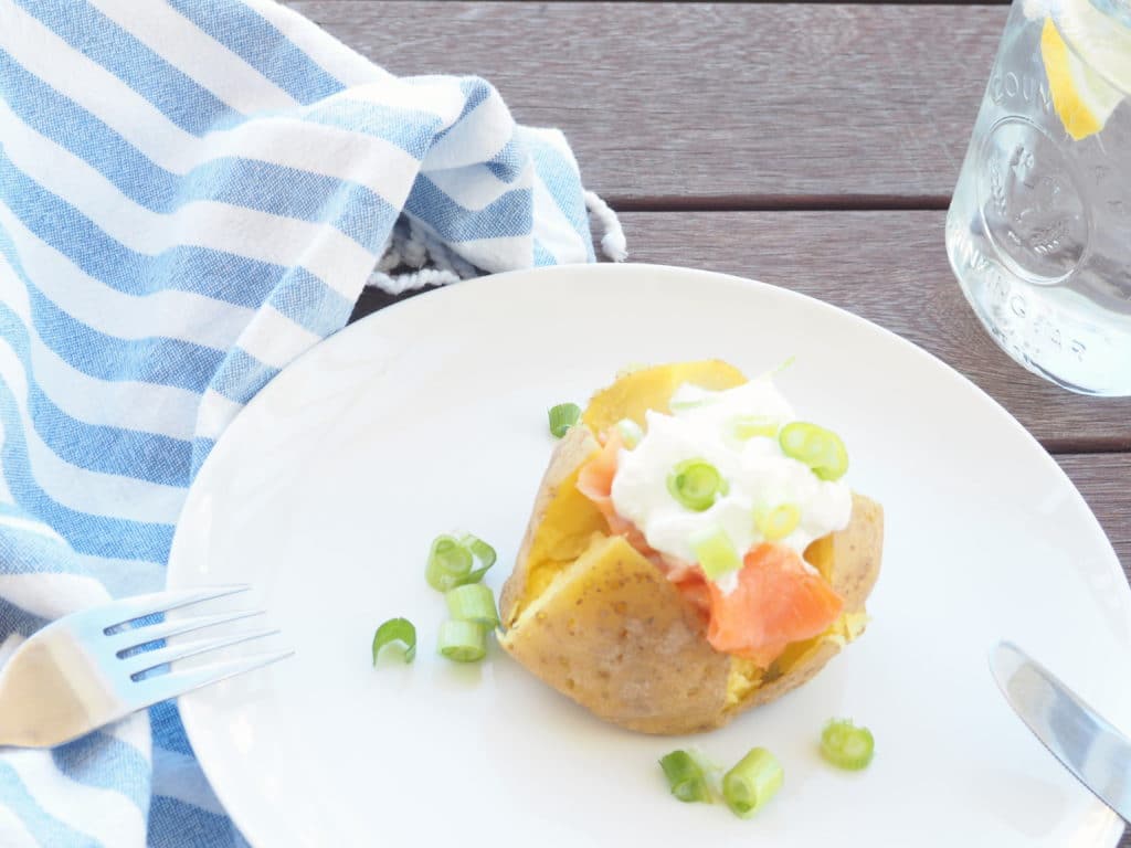 #ad A smoked salmon stuffed Hasselback potato is delicious any time of day--brunch, lunch or dinner! It's nutrient composition of complex carbs, protein, and potassium also makes it ideal for refueling after a workout. Make ahead or, if super short on time, try this quick, microwaved baked potato version instead! #gluten-free #thereciperedux