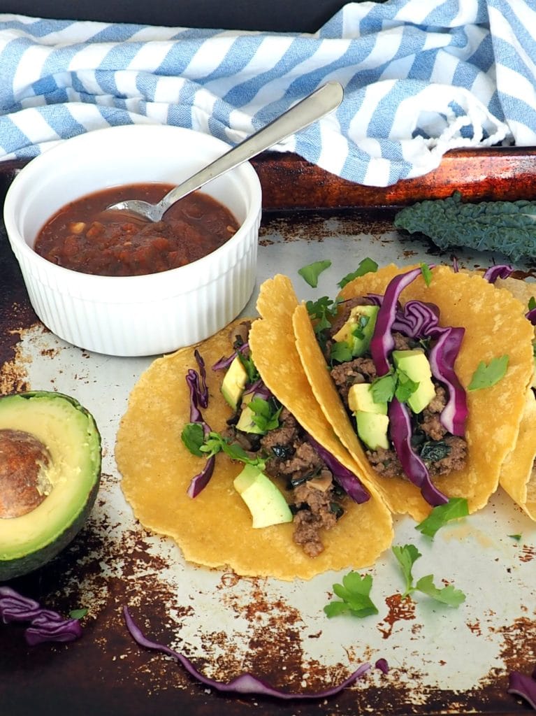 These family favorite beef and kale tacos are sure to be a hit at your dinner table! Plain grass fed ground beef gets a nutrient and flavor boost from fresh chopped onions and kale. This is a great way to get leafy greens into your kids! #glutenfree #dairyfree