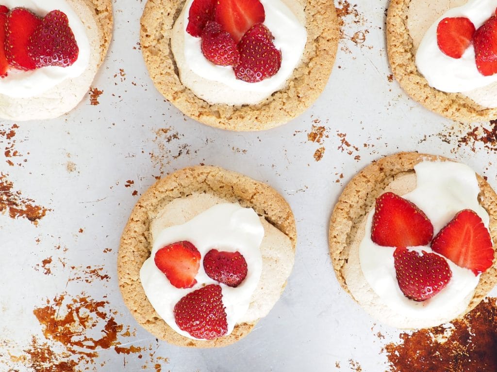 These gluten-free mini Swedish Midsummer Meringue Cakes make a delicious, festive dessert for parties, celebrations, and afternoon coffee with friends (fika). Perfect for strawberry season but also delicious with other berries too. From halsanutrition.com #theRecipeReDux