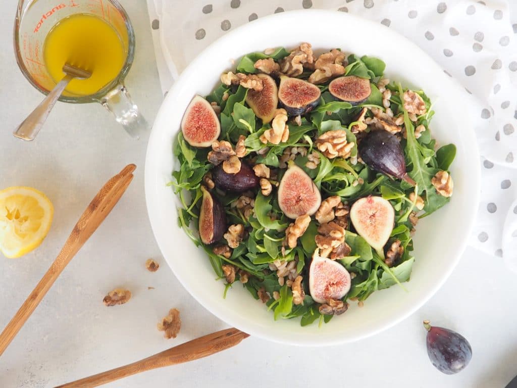 This fig, farro, and arugula salad with walnuts and a honey-lemon vinaigrette is perfect as a side salad, lunch salad, or to bring to a potluck! Keep it #vegetarian or add a little goat cheese and smoked ham or prosciutto. Get the recipe at halsanutrition.com #fig #farro #walnuts #arugula #laborday #potluck