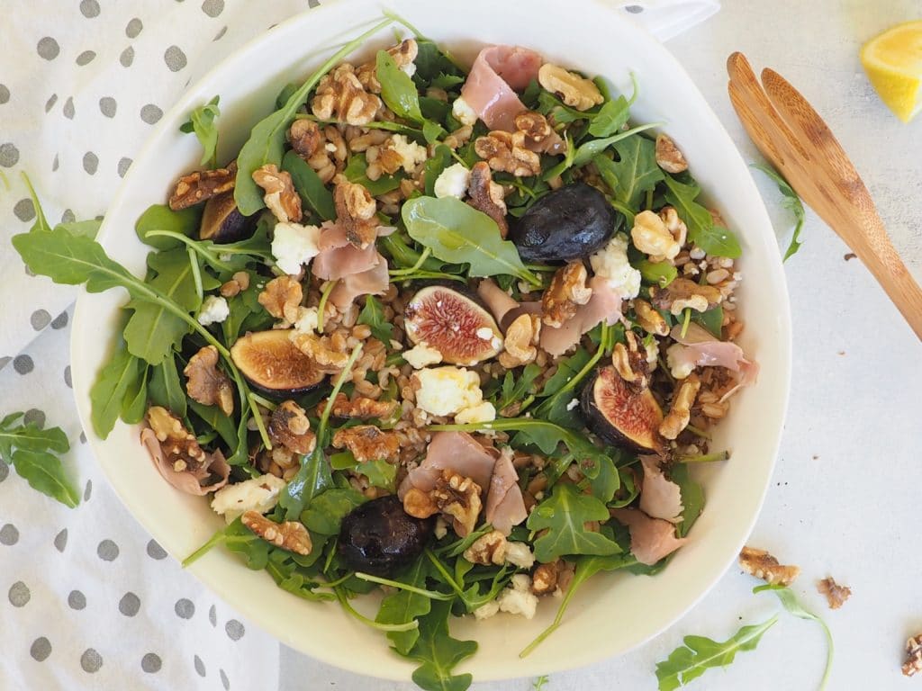 This fig, farro, and arugula salad with walnuts and a honey-lemon vinaigrette is perfect as a side salad, lunch salad, or to bring to a potluck! Keep it #vegetarian or add a little goat cheese and smoked ham or prosciutto. Get the recipe at halsanutrition.com #fig #farro #walnuts #arugula #laborday #potluck