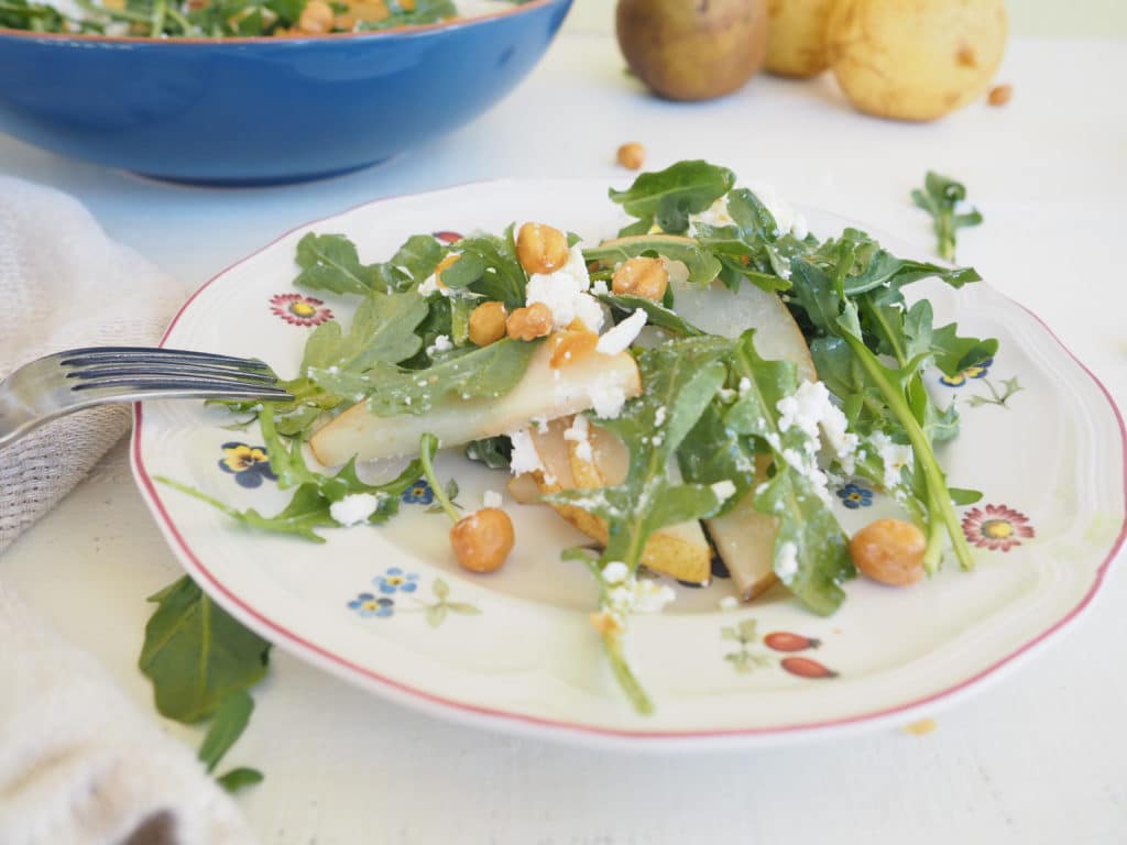 This arugula, pear, and roasted chickpea salad is as well suited for the weeknight dinner table as it is for the holiday buffet. The optional goat cheese adds a creamy texture that pairs perfectly with the pears. Roasted chickpeas add a fun, salty crunch and the apple cider and maple vinaigrette pulls it all together. Vegetarian. Gluten-free. 