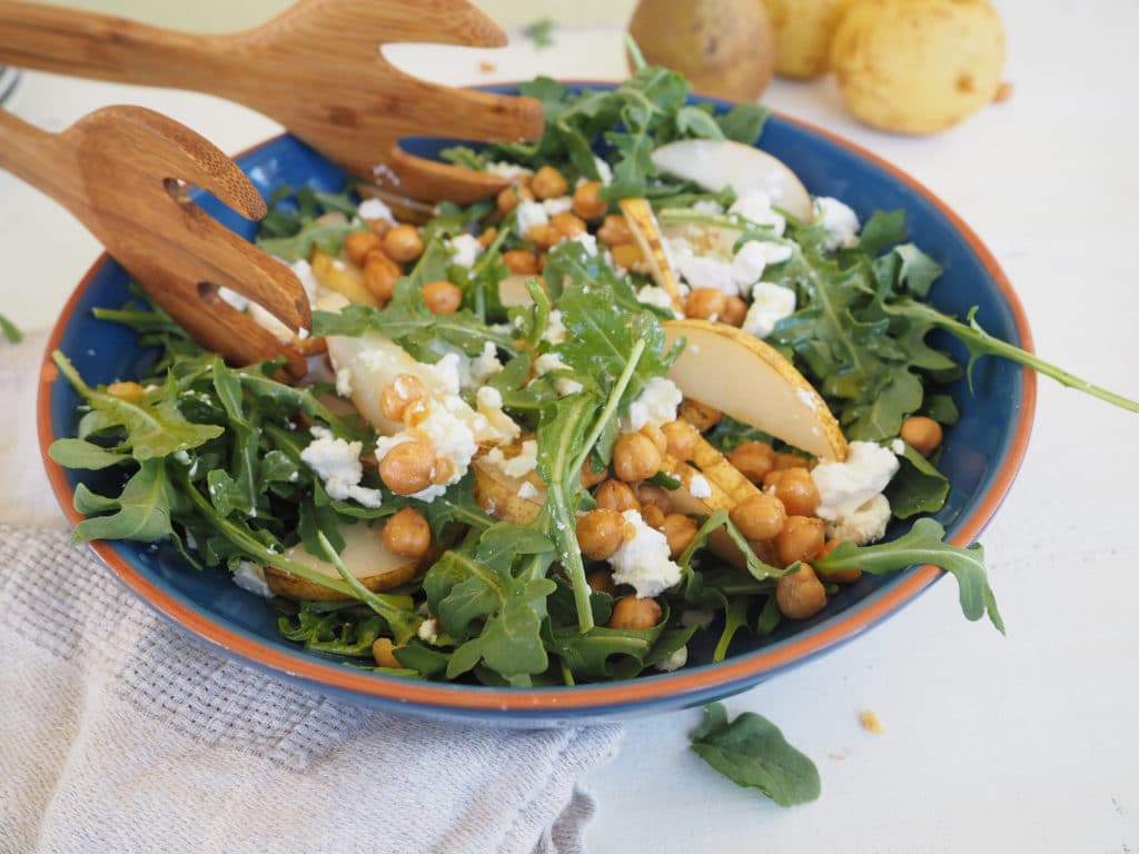This arugula, pear, and roasted chickpea salad is as well suited for the weeknight dinner table as it is for the holiday buffet. The optional goat cheese adds a creamy texture that pairs perfectly with the pears. Roasted chickpeas add a fun, salty crunch and the apple cider and maple vinaigrette pulls it all together. Vegetarian. Gluten-free. 