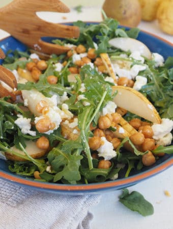 This arugula, pear, and roasted chickpea salad is as well suited for the weeknight dinner table as it is for the holiday buffet. The optional goat cheese adds a creamy texture that pairs perfectly with the pears. Roasted chickpeas add a fun, salty crunch and the apple cider and maple vinaigrette pulls it all together. Vegetarian. Gluten-free.