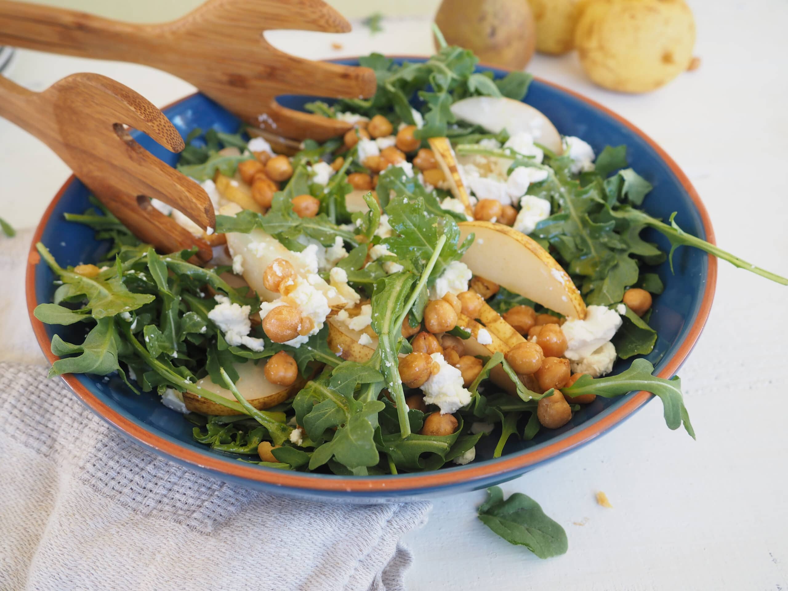 This arugula, pear, and roasted chickpea salad is as well suited for the weeknight dinner table as it is for the holiday buffet. The optional goat cheese adds a creamy texture that pairs perfectly with the pears. Roasted chickpeas add a fun, salty crunch and the apple cider and maple vinaigrette pulls it all together. Vegetarian. Gluten-free.