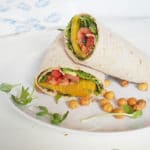 This Roasted Beet, Avocado, and Tomato Wrap is the perfect summer sandwich. Like having a salad in a wrap, it's packed with deliciousness in every bite. With microgreens, toasted sesame seeds, and fresh lemon juice, this is no ordinary wrap. Keep it vegan or add a little feta cheese if you like. Serve with roasted chickpeas and fresh summer berries. From halsanutrition.com.