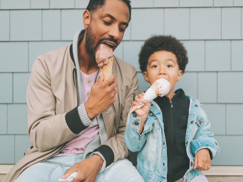 father and son enjoying ice cream 