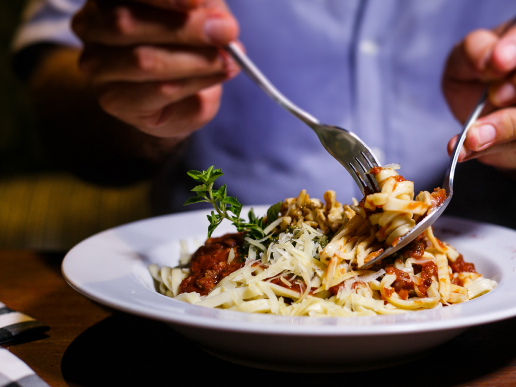 man eating pasta 